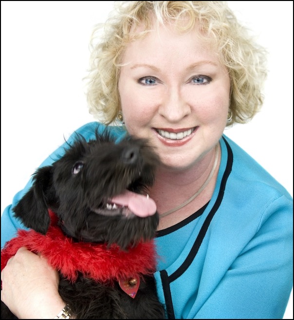 Smiling woman with small black terrier